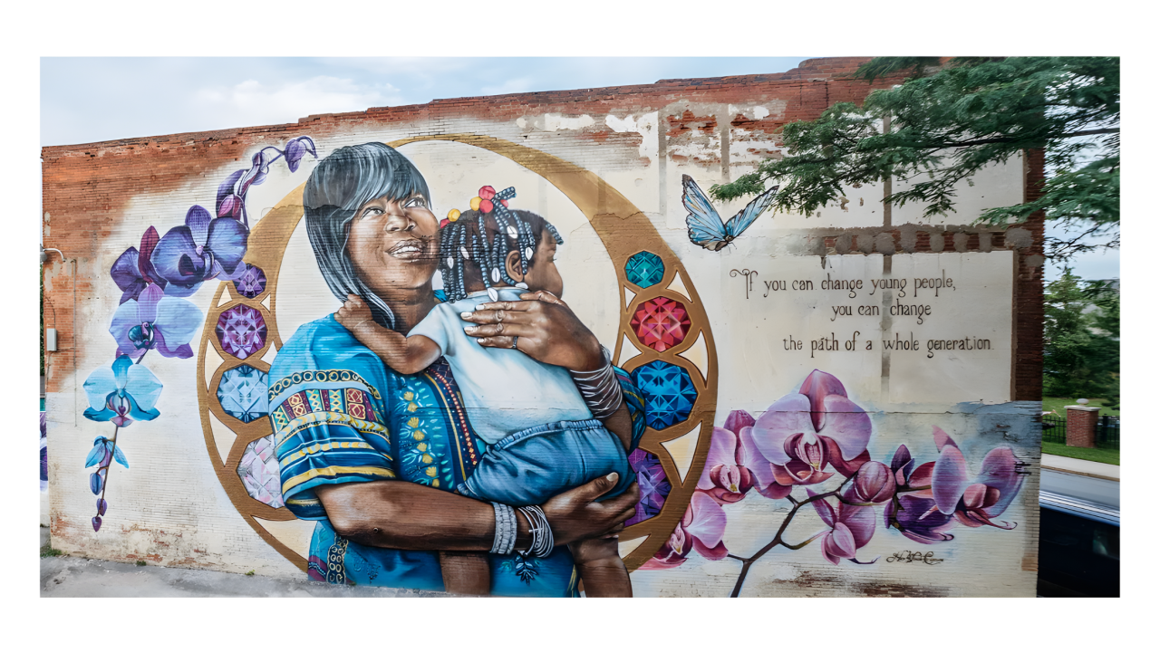 Mural showing a black woman embracing a black child
