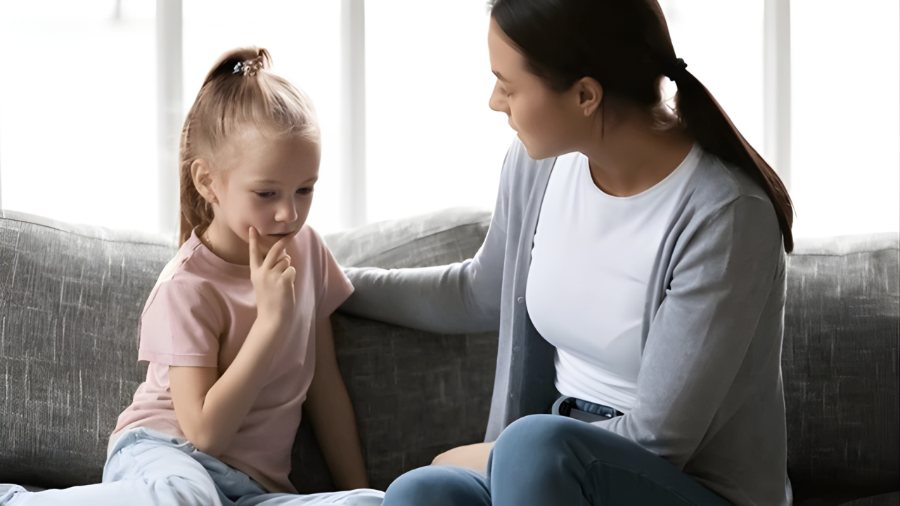 a serious looking mother talking to a female child